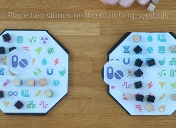 two board game boards with scientific symbols and wooden cubes